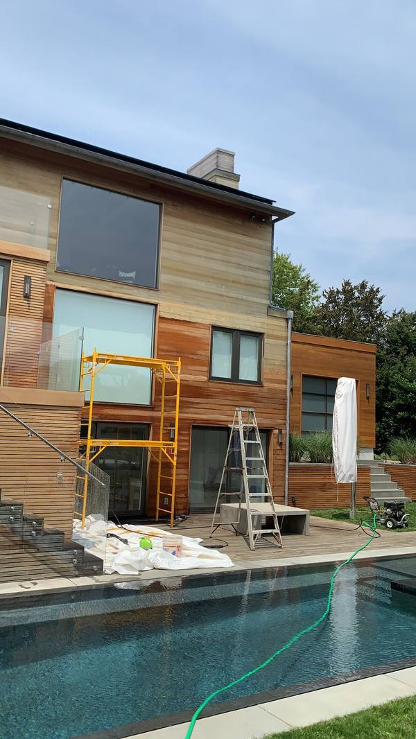 Exterior staining of a poolside home in East Hampton NY